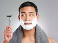Asian man, razor and beard with shaving cream or hair removal grooming, cleaning or grey background. Male person Royalty Free Stock Photo