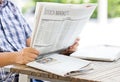 Asian Man Reading The Financial Newspaper. Royalty Free Stock Photo