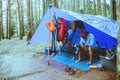 Asian man relax travel nature in the holiday.Take a picture Nature Study in the Jungle camping on the Mountain. rainy season at Royalty Free Stock Photo