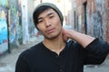 Asian man rocking a beanie outdoors