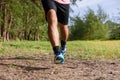 Asian man running on forest path during sunset, close up legs and feet Royalty Free Stock Photo