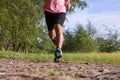 Asian Man running on forest path during sunset, close up legs and feet Royalty Free Stock Photo