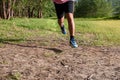 Asian Man running on forest path during sunset, close up legs and feet Royalty Free Stock Photo