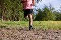 Asian Man running on forest path during sunset, close up legs and feetFat Man running on forest path during sunset, close up legs Royalty Free Stock Photo