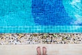 Asian man`s feet at the edge of the pool. He is going to swim Royalty Free Stock Photo