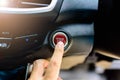 Asian man`s finger pressing a button to start or stop car engine Royalty Free Stock Photo