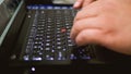 An Asian manÃ¢â¬â¢s hands are constantly tapping on the keyboard, using a laptop to deal with documents