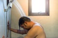 Asian man shower in bathroom for clean a body Royalty Free Stock Photo