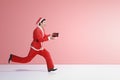 Asian man in Santa costume running while holding the gift box Royalty Free Stock Photo