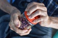 Asian man screwing the cap of glass bottle. Concept of hand muscle strength and power Royalty Free Stock Photo