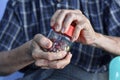 Asian man screwing the cap of glass bottle. Concept of hand muscle strength and power Royalty Free Stock Photo