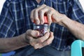 Asian man screwing the cap of glass bottle. Concept of hand muscle strength and power Royalty Free Stock Photo