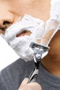 Asian man shaving