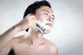 Asian man is shaving