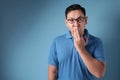 Asian Man Shocked and Closing his Mouth Royalty Free Stock Photo