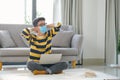 Asian man sitting on floor and working on laptop with books Royalty Free Stock Photo