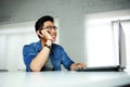Asian man sitting at his workplace Royalty Free Stock Photo