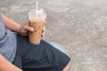Asian man sitting and relaxing with pastic coffee cup Royalty Free Stock Photo