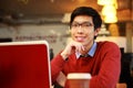 Asian man sitting at the table with laptop Royalty Free Stock Photo