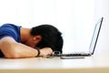 Asian man sleeping on the table with laptop Royalty Free Stock Photo