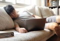 Asian man sleeping while working form home on sofa Royalty Free Stock Photo
