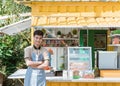 Asian man small business owner at his shop made of truck container Royalty Free Stock Photo