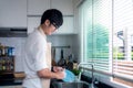 Asian man smile and washing a dish in kitchen room Royalty Free Stock Photo