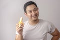 Asian Man Smiling with Banana