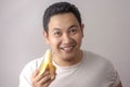 Asian Man Smiling with Banana