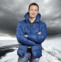 Asian man stand on snow road in winter