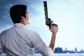 Asian man standing with a gun on his hand on the city Royalty Free Stock Photo