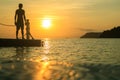 Asian man standing and jumping on floating pier at sunrise , Silhouette body of asian people early morning Royalty Free Stock Photo