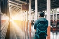 Asian man standing at platform train station waiting and looking Royalty Free Stock Photo