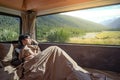 Asian man staying in the blanket in camper van Royalty Free Stock Photo