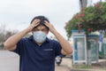 Asian man in the street wearing protective masks., Sick man with flu wearing mask and blowing nose into napkin as epidemic flu con Royalty Free Stock Photo