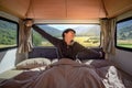 Asian man stretching arms in camper van Royalty Free Stock Photo