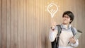 Asian man student pointing at light bulb Royalty Free Stock Photo