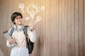 Asian man student pointing at light bulb Royalty Free Stock Photo