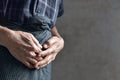 Asian man suffering from abdominal pain. It can be caused by cystitis, enteritis, colitis, appendicitis, bladder distension, food Royalty Free Stock Photo