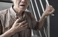 Asian man suffering from tightness of chest. It can be caused by asthma, bronchitis, bronchiolitis, pneumonia, myocardial