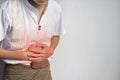 Asian man suffering from upper abdominal pain. It can be caused by stomach ache, enteritis, colitis, appendicitis, hepatitis,