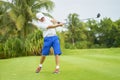 Asian man swinging club for tee-off in course Royalty Free Stock Photo