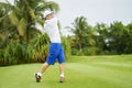 Asian man swinging club for tee-off in course Royalty Free Stock Photo