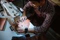 asian man tailor sewing leather using sewing machine