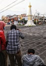 Asian man taking a photo of a historical monument in the center of Yogyakarta