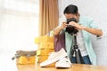 Asian man taking photo to shoes with digital camera for post to selling online on the internet Royalty Free Stock Photo