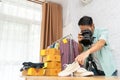 Asian man taking photo to shoes with digital camera for post to selling online Royalty Free Stock Photo