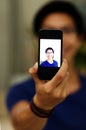 Asian man taking self picture with smartphone Royalty Free Stock Photo