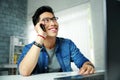 Asian man talking on the phone at his workplace Royalty Free Stock Photo