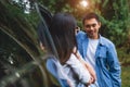 Asian man talking to women in car during travel in forest. Boy flirting girls for meeting. People lifestyles and weekend tour Royalty Free Stock Photo